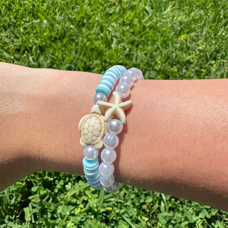 Here's my beachy blue turtle bracelet set! It comes with a blue + white bracelet with a turtle & a pearl + starfish bracelet! Hope you guys like it!! (Colors may be a bit different in real life) Casual Beaded Bracelets With Starfish Charm For The Beach, Casual Adjustable Starfish Beaded Bracelets, Casual Bracelets With Starfish Charm For Vacation, Casual Blue Beaded Bracelets With Starfish Charm, Casual Blue Jewelry With Starfish Charm, Beachy White Starfish Bracelet, Beachy White Starfish-shaped Bracelet, White Starfish Charm Bracelet For Beach Season, White Starfish Bracelet With Ocean-inspired Style