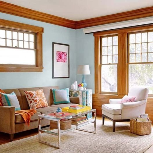 a living room filled with furniture and windows