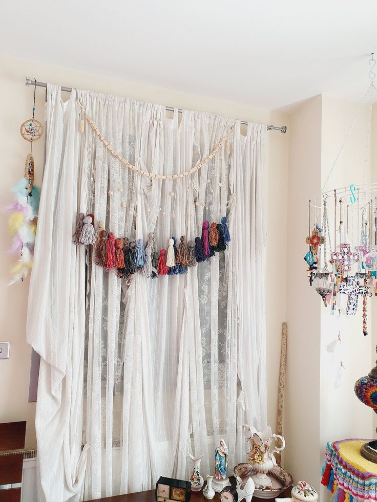 there is a curtain with many beads hanging from it's sides in front of a window