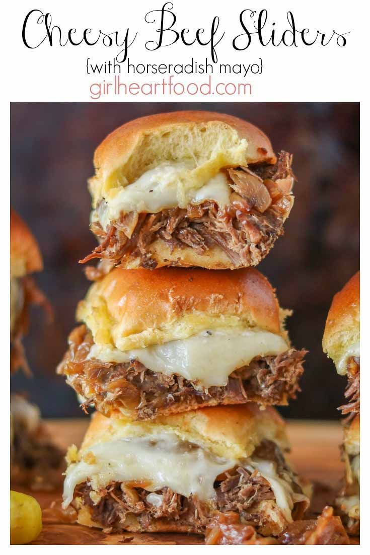 three beef sliders stacked on top of each other with melted cheese and meat in the middle