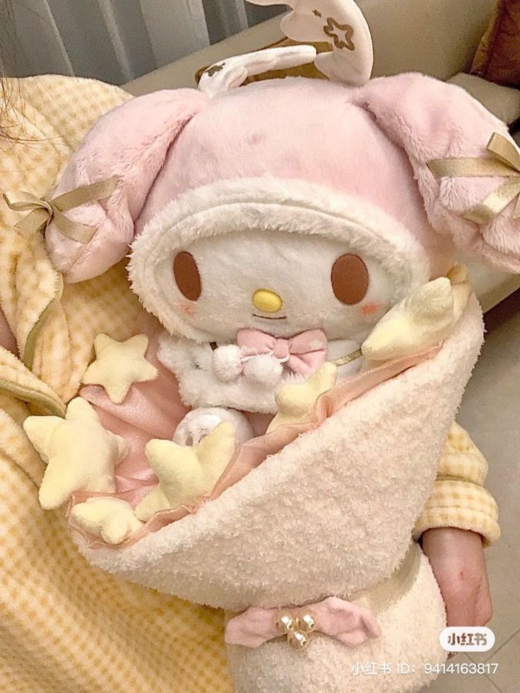 a small stuffed animal wrapped in a blanket