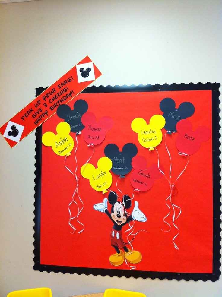 the mickey mouse bulletin board is decorated with yellow chairs and red wall hanging from it