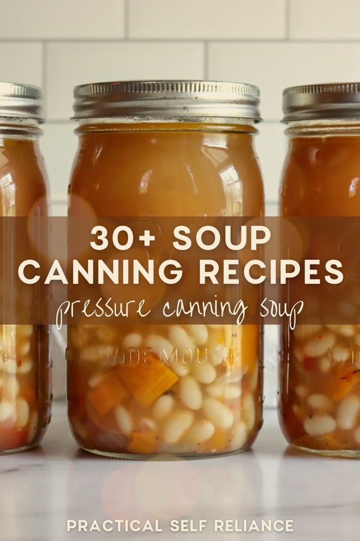 three jars filled with canned soup sitting on top of a counter