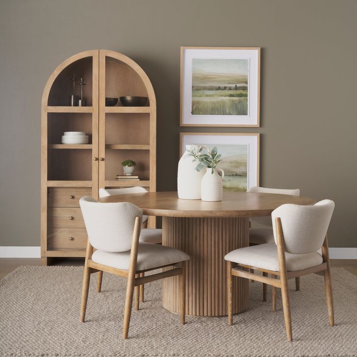 a dining room table with two chairs around it