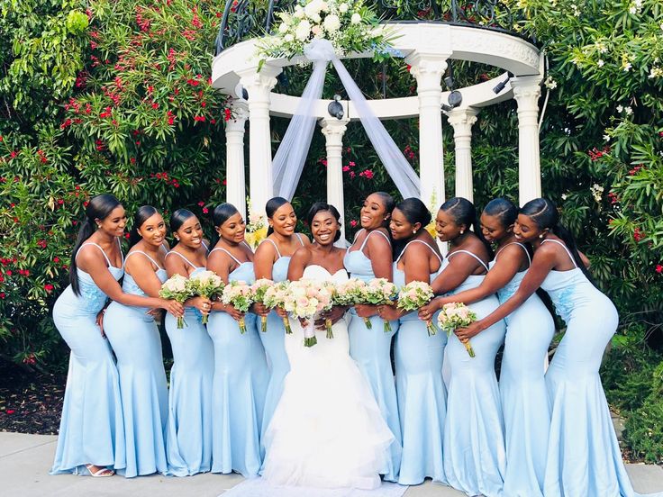 a group of women standing next to each other in front of a white gazebo