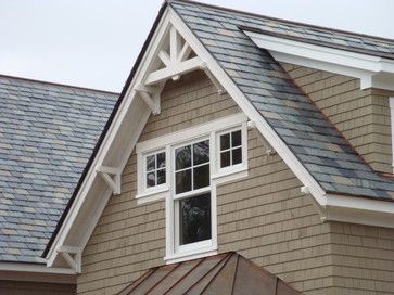 a brown house with white windows and shingles