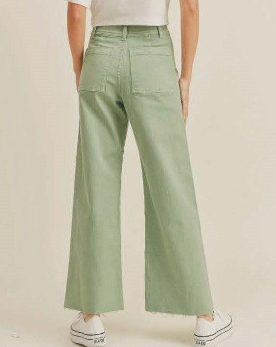 If you think your soulmate might be avocado toast, then these are the wide-leg pants for you. Our Avocado Queen Pants are made from stretch, loose-fit organic cotton denim in a fun, sage green color. Pants feature a classic, deep pocket construction, zip-fly closure, high-rise waist with wide, relaxed legs. Fun square front and back pockets Raw-edge hem On-trend, subtle sage green color Models are 5’6 and wearing a size small 98% organic cotton / 2% spandex *P.S. Models are wearing our Back Toge Casual Olive Wide Leg Pants With Pockets, Olive High-waisted Pants For Spring, Relaxed Fit Wide Leg Pants In Khaki, Solid Cotton Flare Jeans For Fall, Trendy Olive Pants For Spring, Cotton Cropped Wide Leg Pants With Five Pockets, Green Wide Leg Cargo Pants With Five Pockets, Spring Cotton Wide Leg Pants With Five Pockets, Cotton Wide Leg Pants With Five Pockets For Spring