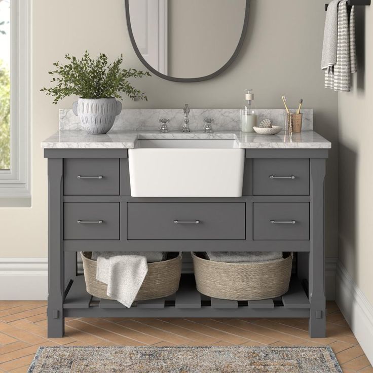 a bathroom with a sink, mirror and rug