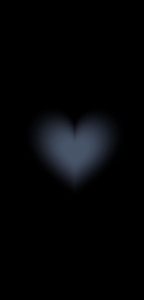 a blurry image of a heart in the dark with only one light on it