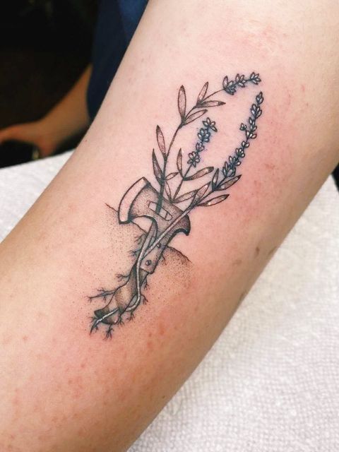 a tattoo on the arm of a woman with flowers