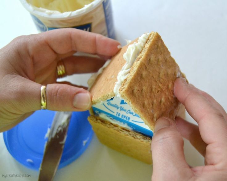 a person is cutting into a sandwich on a table