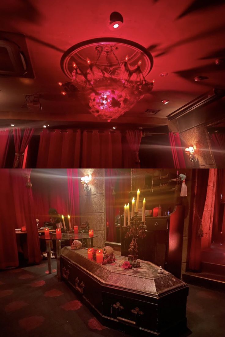 a room with red curtains and candles in it