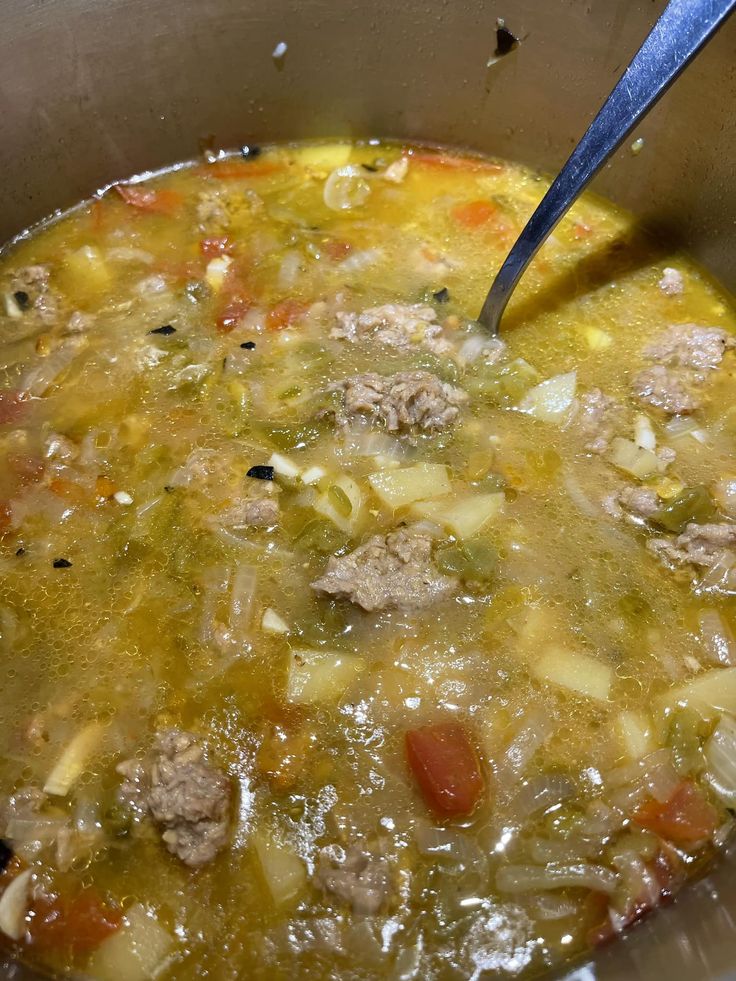 a large pot filled with soup and meat