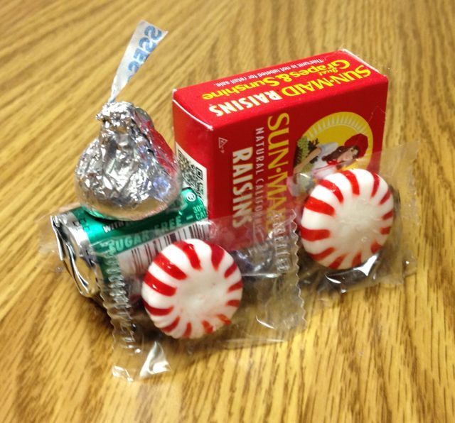 two candy candies wrapped in plastic wrapper on a table next to a box