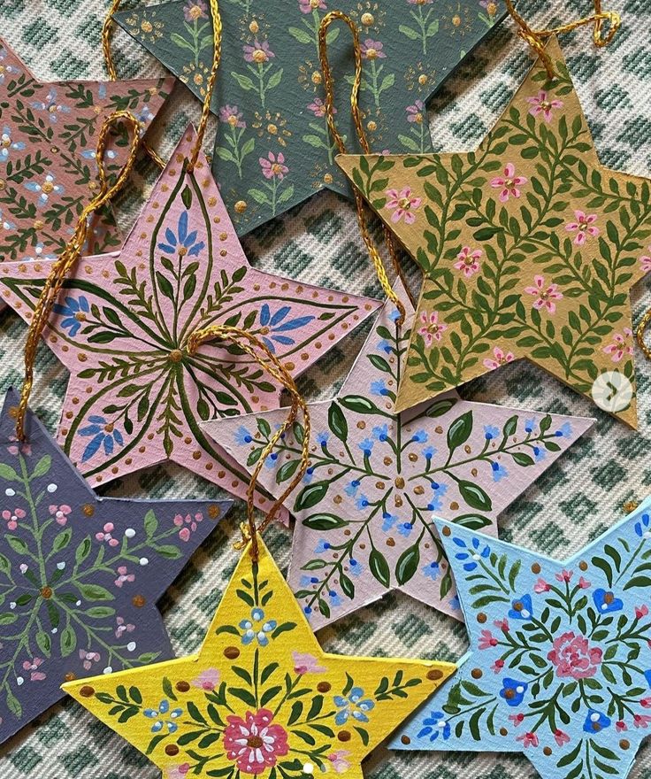 several star shaped ornaments are hanging on a table