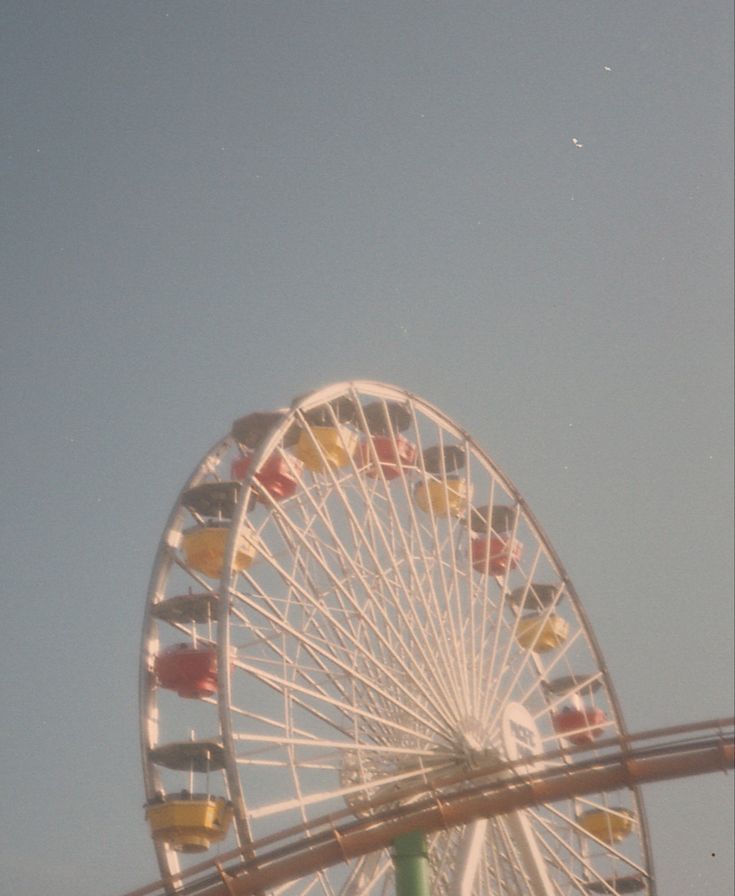 a ferris wheel with flags flying in the air