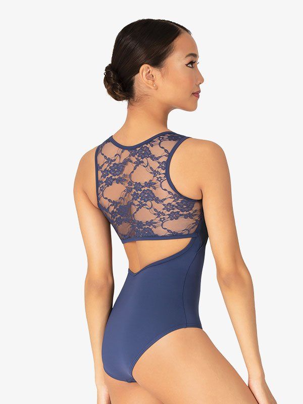 a woman in a blue bodysuit with an open back and lace on the top