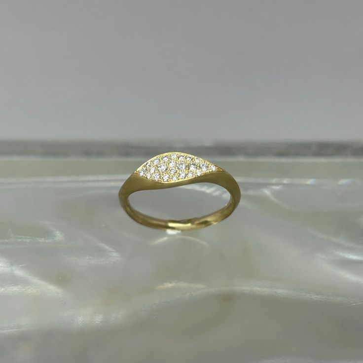 This delicate ring is 10k yellow gold and adorned with diamonds. size 6 Made in Brooklyn, NY