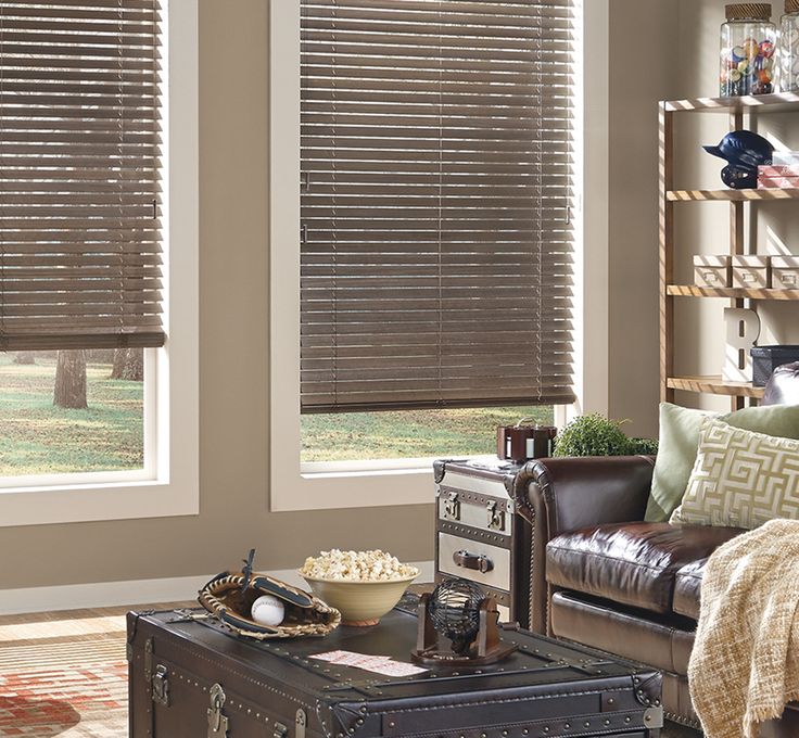 a living room filled with furniture and windows covered in blinds