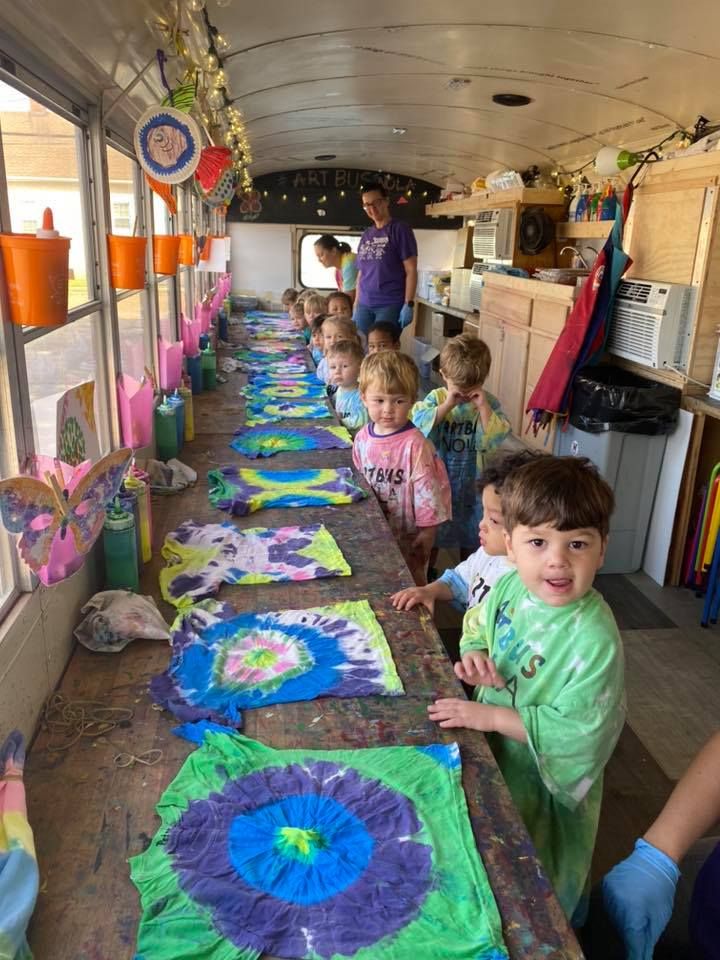 children are lined up on the long table