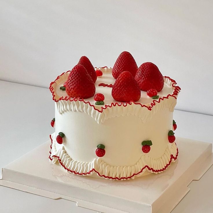 a white cake with strawberries on top