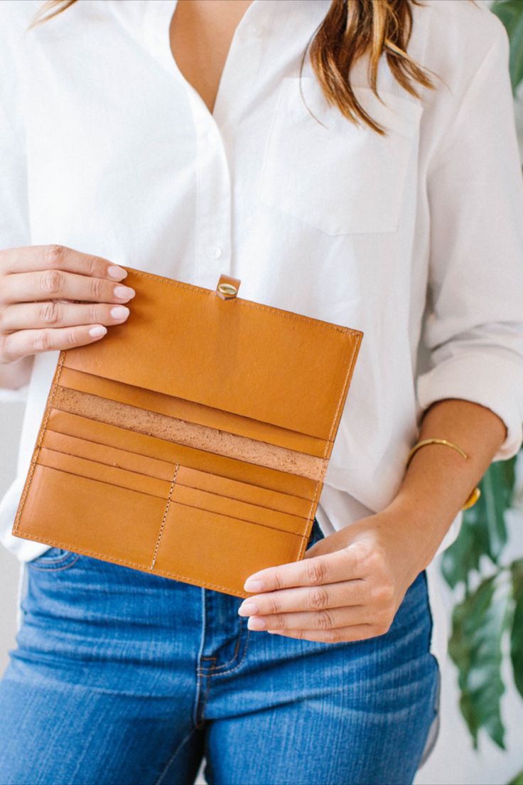 The Lincoln Park Wallet in tan is as sleek as its namesake neighborhood in Chicago. Crafted from beautiful vegetable tanned leather that wears wonderfully over time, this structured piece only gets better with age. The brass snap closure and K.Slade debossed logo polish off this wallet that can stylishly contain cash, receipts and up to twelve credit cards. #leather #wallet #handbag #organize #purse Luxury Tan Wallet With Bill Compartment, Classic Leather Wallet With Snap Closure, Brown Vegetable Tanned Leather Wallets For Everyday, Tan Leather Wallet On Chain, Classic Vegetable-tanned Wallets For Daily Use, Everyday Leather Wallet On Chain With Gold-tone Logo, Everyday Brown Vegetable-tanned Wallet, Travel Leather Wallet On Chain With Gold-tone Hardware, Classic Leather Wallet, Vegetable-tanned