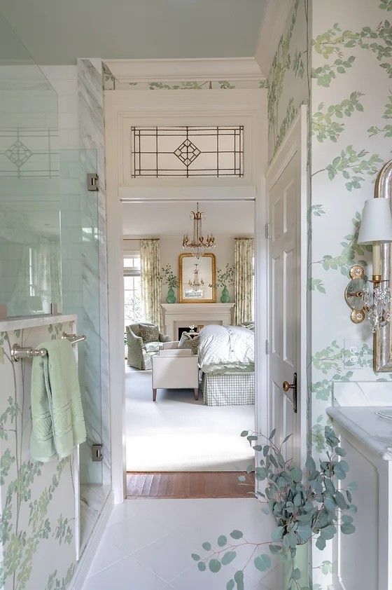 the hallway is decorated with green and white wallpaper, along with a chandelier