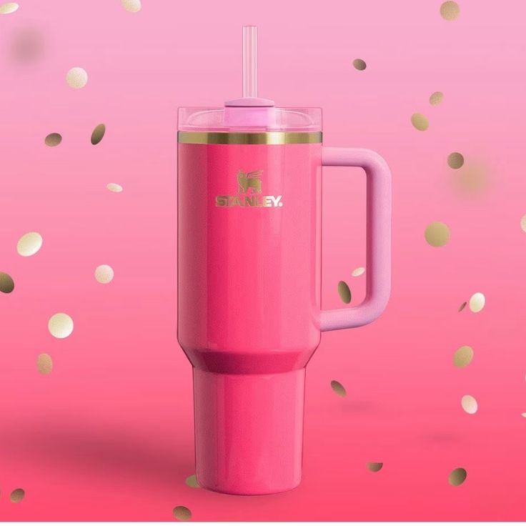 a pink blender sitting on top of a pink table next to confetti