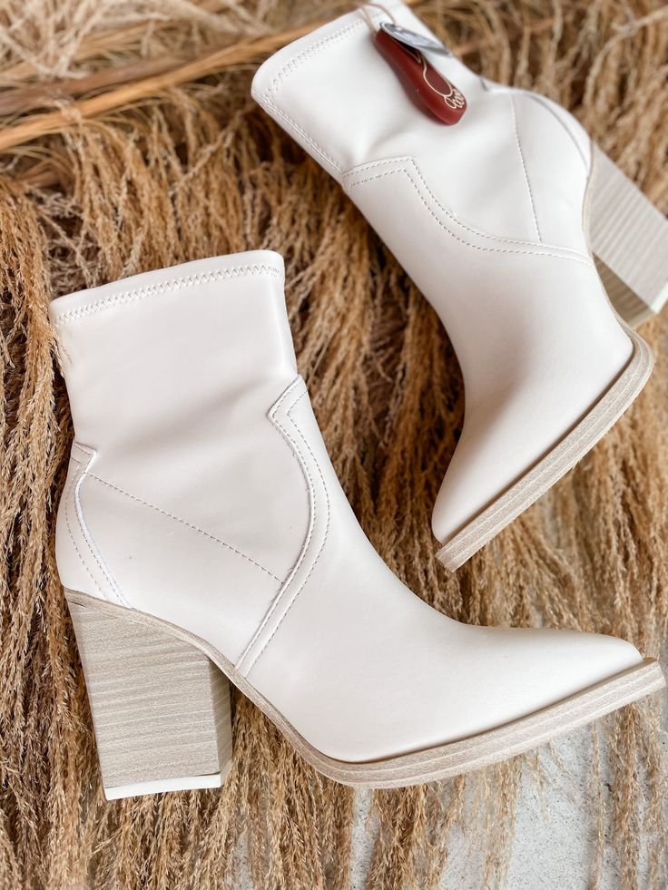 Step out in style with the Rachell Bootie! This classic neutral pointed toe bootie is the perfect finishing touch to any outfit - available in ivory or black, so you can choose the look that best suits your style. Make a statement with your footwear! Oh, and did we mention it looks amazing? 3 inch heel Beige Booties For Work In Fall, Beige Fall Booties For Workwear, Fall Beige Booties For Workwear, White Mid-calf Boots With Stacked Heel For Spring, White Mid-calf Boots With Stacked Heel For Fall, Spring Fitted Almond Toe Booties, Trendy Fitted Booties With Block Heel, White Pointed Toe Mid-calf Boots Medium Width, White Mid-calf Boots With Pointed Toe