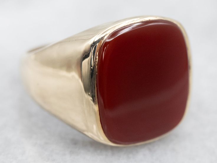 This beautiful Mid-Century mounting combines sleek styling and intense color. This beautifully styled ring with a warm rich Carnelian center. Carnelian is the reddish-orange version of Chalcedony and can either be uniformly colored or have visible bands through the stone.Material: 10K Yellow GoldGem: CarnelianGem Measurements: 13.9 x 16.2 mm, Rectangle Cushion Cut Size of Ring: 9.50Marks: "JASON 10K" Stamped on the inside band Classic Carnelian Signet Ring For Formal Occasions, Classic Carnelian Signet Ring For Formal Events, Classic Red Signet Ring For Formal Occasions, Modern Red Rings For Formal Occasions, Modern Red Ring For Formal Occasions, Formal Carnelian Signet Ring With Polished Finish, Classic Carnelian Signet Ring With Polished Finish, Classic Carnelian Rings With Polished Finish, Red Carnelian Ring With Polished Finish