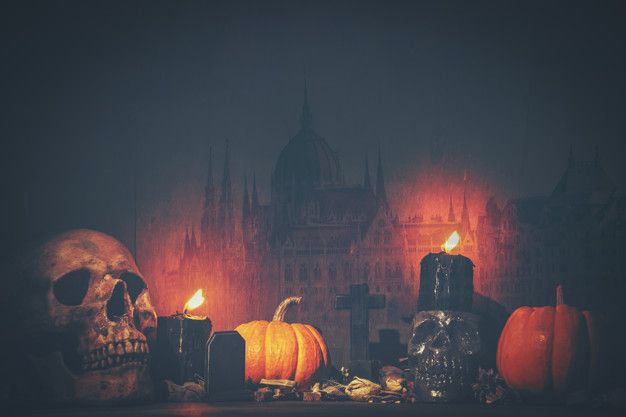 halloween decorations with candles and skulls in front of a castle