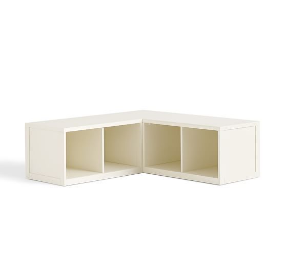 a white corner shelf with two open compartments