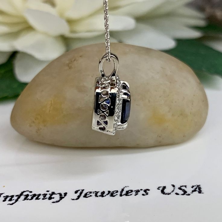 "The pendant pictured is a lab created blue sapphire and moissanite halo #6302 -Approximate total carat weight: approx. 1.90ctw diamond equivalent -Center Stone Size: 7x7mm - approx. 1.70ct diamond equivalent -Center Stone Shape: cushion cut -Gem Type: lab created sapphire -Stone Clarity: VS2 -Stone Color: Blue -Moh's Scale: 9 hardness -Accent Stone Size: 20 round approx. 0.20ct. diamond equivalent -Gem Type: moissanite -Stone Clarity: VS2 -Stone Color: FG -Moh's Scale: 9.5 hardness -Metal Type Anniversary Necklace With Lab-created Sapphire Birthstone, Anniversary Lab-created Sapphire Diamond Cut Necklaces, Anniversary Diamond Cut Lab-created Sapphire Necklace, Anniversary Diamond Cut Sapphire Necklaces, Anniversary Sapphire Necklace With Diamond Cut, Diamond Cut Lab-created Sapphire Necklace As Gift, Lab-created Sapphire Necklace With Diamond Accents, Lab-created Sapphire Necklace With Diamond Accents As Gift, Fine Jewelry Sapphire Necklaces For Anniversary