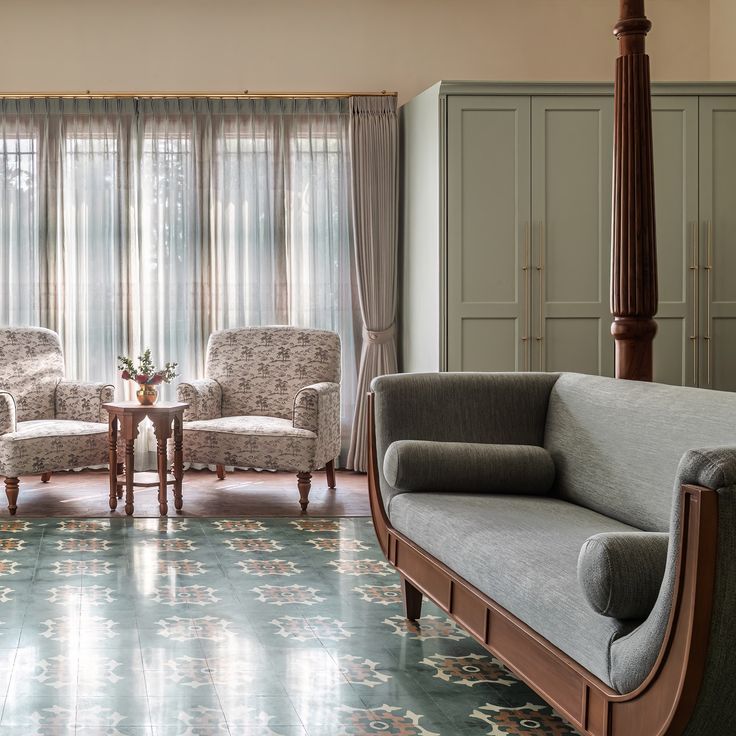 a living room filled with furniture next to a window