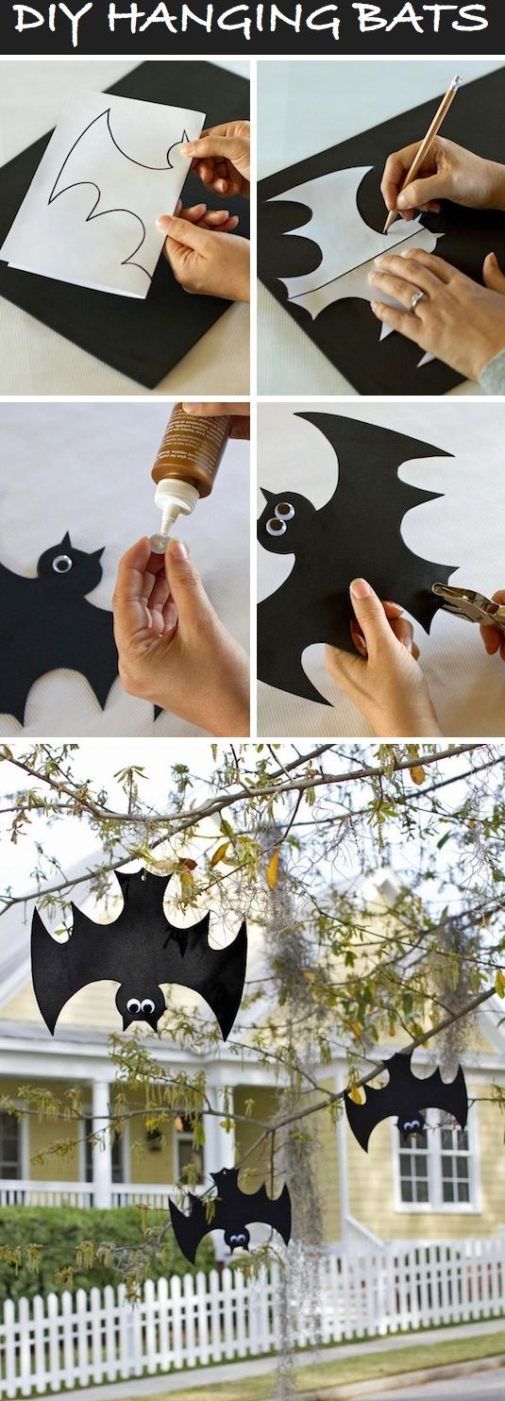 halloween decorations made out of paper bats hanging from a tree