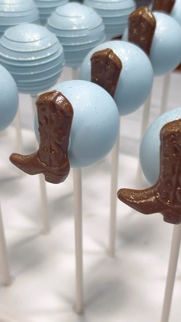 several blue and brown candy lollipops with cowboy boots on them