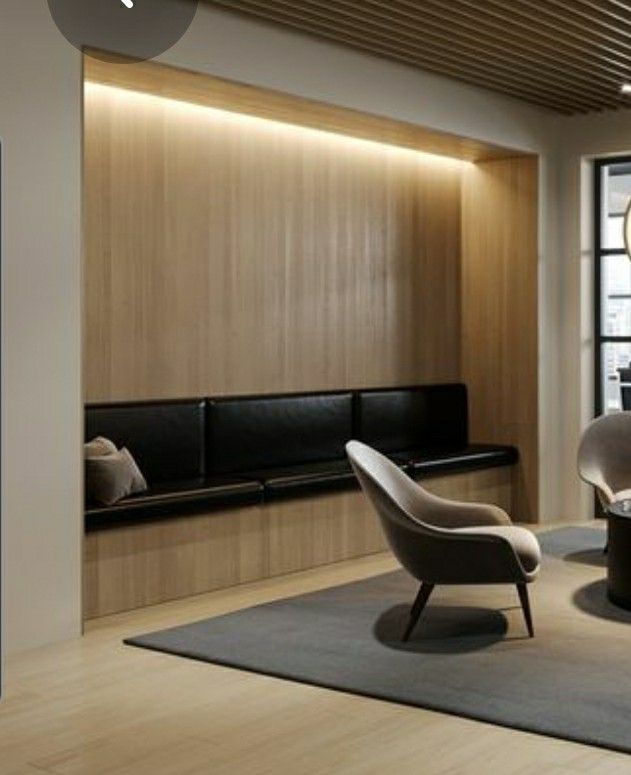 a living room filled with furniture next to a window covered in light colored wood paneling