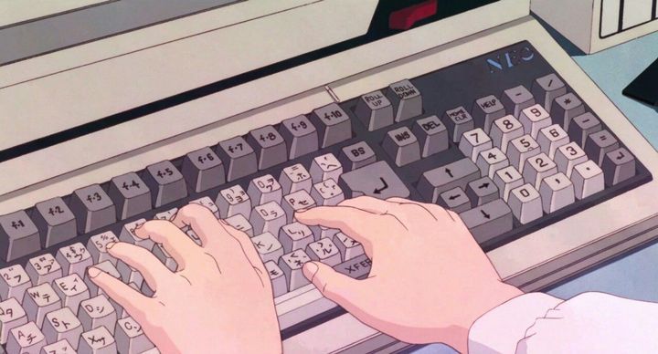 a person typing on an old fashioned computer