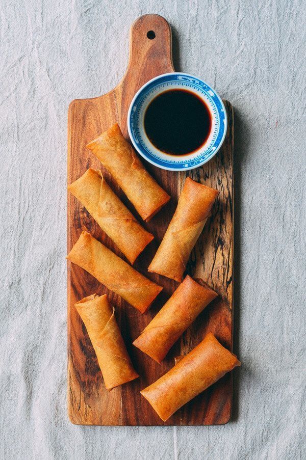 some food on a cutting board with a cup of coffee