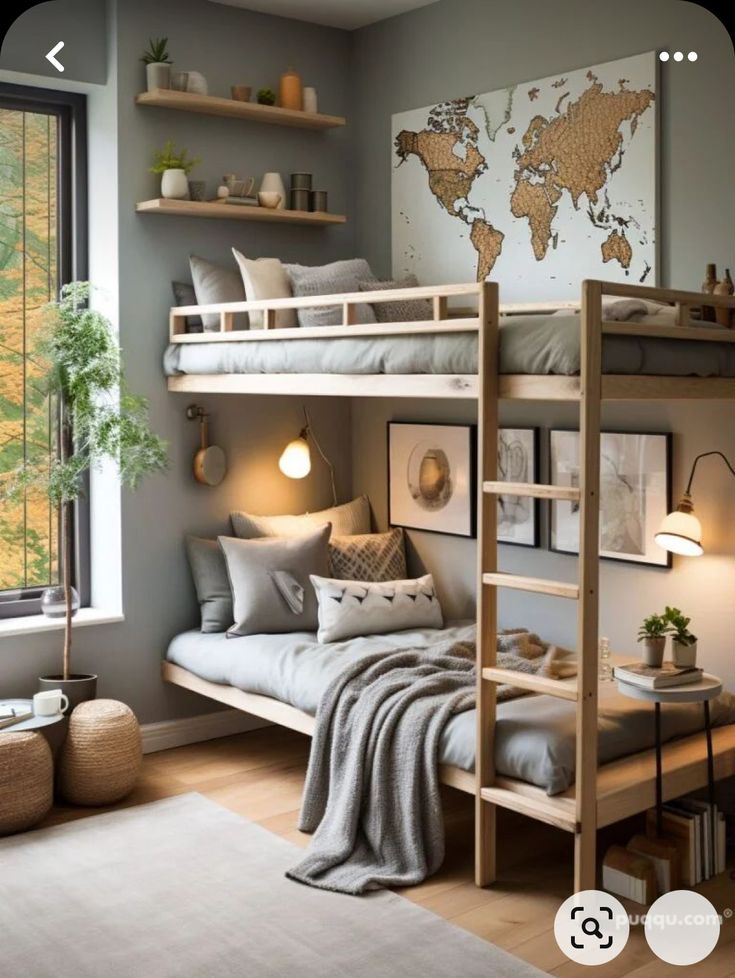 a bedroom with bunk beds and a map on the wall above it in front of a window