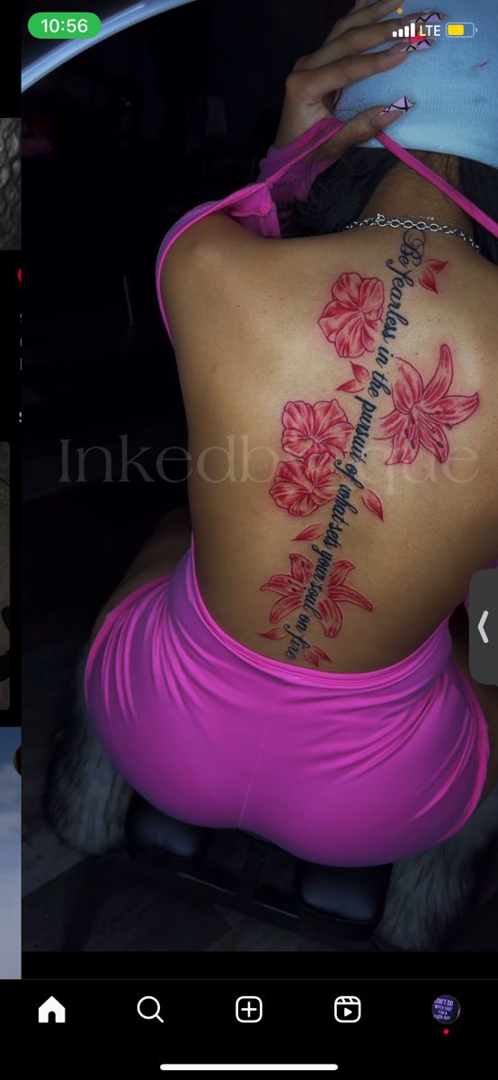 the back of a woman's body with flowers on it