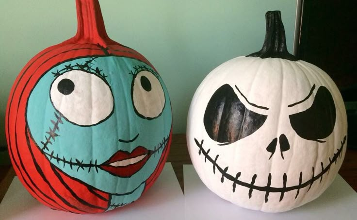 two pumpkins decorated to look like jack skellingy and jack - o'lantern