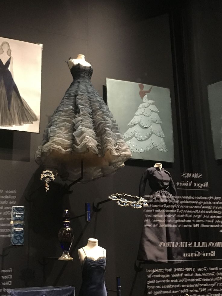 mannequins and dresses on display in a museum