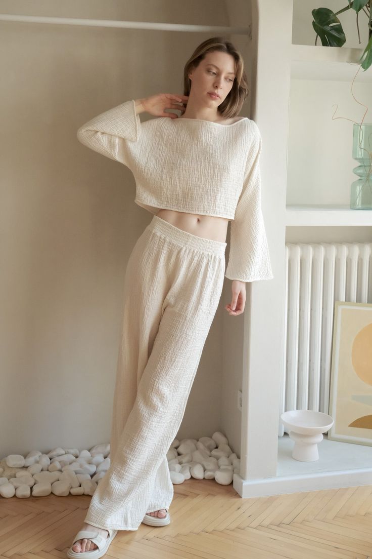 Walk into your day with our soft and light-weighted cotton Skye Palazzo Pants Natural With Gold Stripes, designed to make you feel confident and relaxed throughout your day. Feel at your best silhouette with these loose-fitting lounge pants featured with elasticated high waist to accentuate your natural waist. - 100% Turkish cotton- One size fits most- Elasticated waist Comfortable Straight Leg Harem Pants For Loungewear, Relaxed Cotton Loungewear Bottoms, Cotton Wide Leg Sleepwear For Relaxation, Wide Leg Cotton Sleepwear For Relaxation, Relaxed Cotton Ankle-length Harem Pants, Relaxed Cotton Harem Pants Ankle-length, Wide Leg Cotton Pants For Loungewear, Relaxed Ankle-length Harem Pants For Loungewear, Cotton Harem Pants With Elastic Waistband For Loungewear