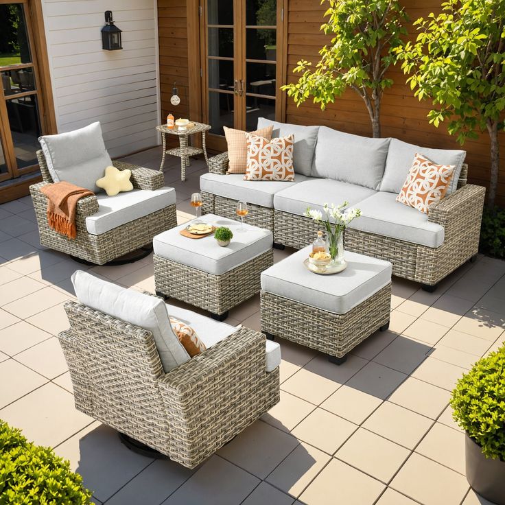 an outdoor living room with wicker furniture