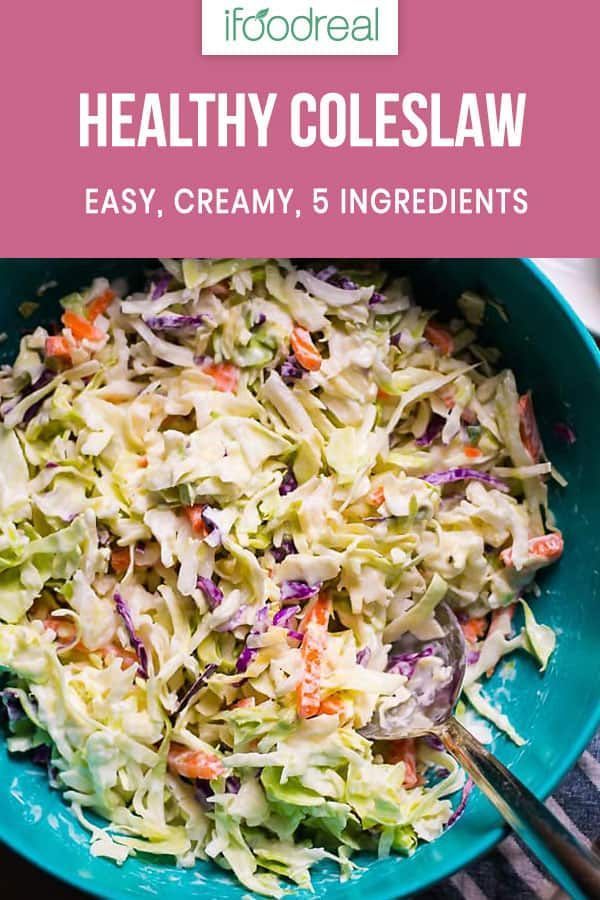 a blue bowl filled with coleslaw and carrots on top of a table