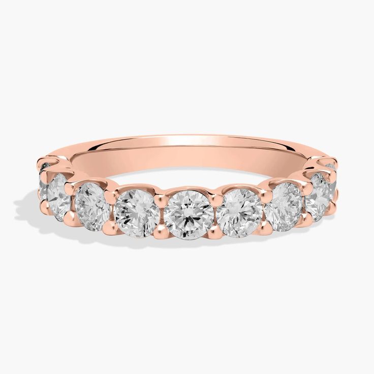 a rose gold wedding band with five stones on the side and four rows of diamonds