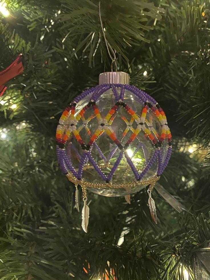 a glass ornament hanging from a christmas tree