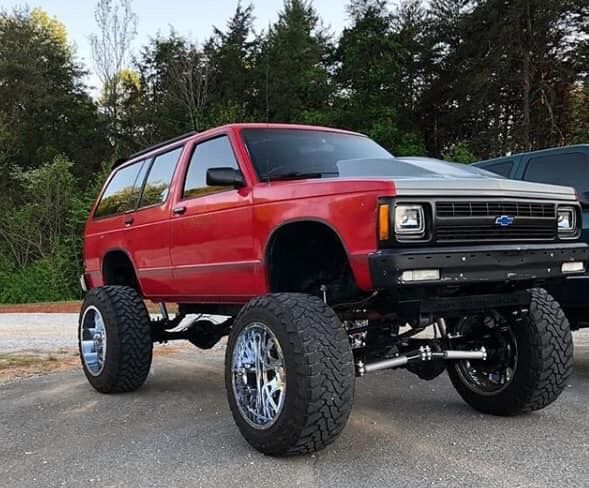 a red truck is parked in a parking lot