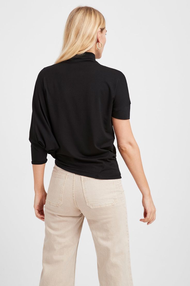 Stunning day-to-night style. A tale of two halves, our Hamilton Top is all about eye-catching and versatile asymmetry. Crafted from soft, high-stretch and sustainable European jersey with a relaxed fit, she's designed with a dropped-shoulder short sleeve on one side and a mid-length batwing sleeve that drapes down your arm on the other. An asymmetric bottom hem creates a slant on the hip. The look is pure geometric chic. [SPLIT] Natalee, in off white, is 5'10" (178 cm) tall, wearing size M. Mari Black 4-way Stretch Tops For Spring, Black 4-way Stretch Elastane Tops, Versatile Black Top With 4-way Stretch, Versatile Black 4-way Stretch Top, Modern Asymmetrical Solid Color Tops, Chic Relaxed Fit Tops Made Of Modal, Versatile Viscose Tops For Fall, Versatile Viscose Tops For Loungewear, Chic Relaxed Fit Modal Tops